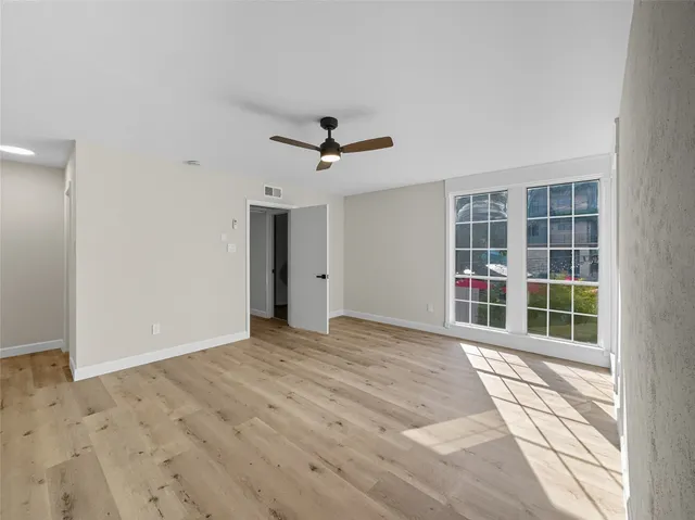 an empty room with windows and closet