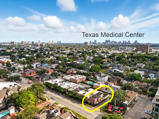 front view of house with a yard and potted plants