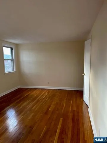 a view of an empty room and wooden floor