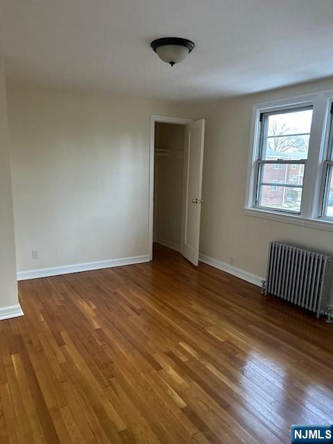 425 Ridge Road, Unit K North Arlington, NJ 07031 - Photo 4 of 6 an empty room with wooden floor and windows