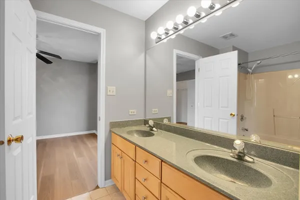 a bathroom with a sink double vanity and a mirror