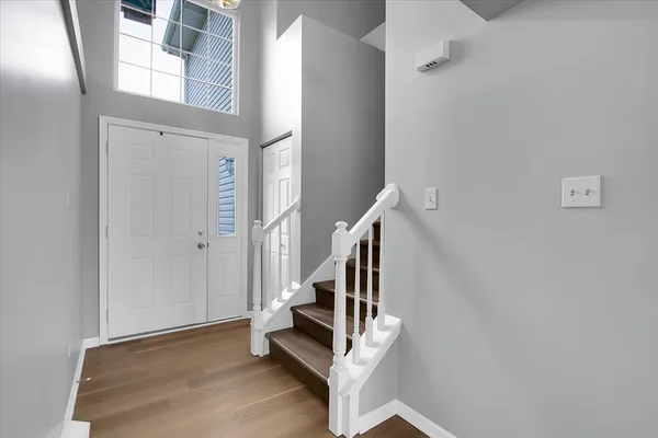 a view of entryway with stairs and wooden floor