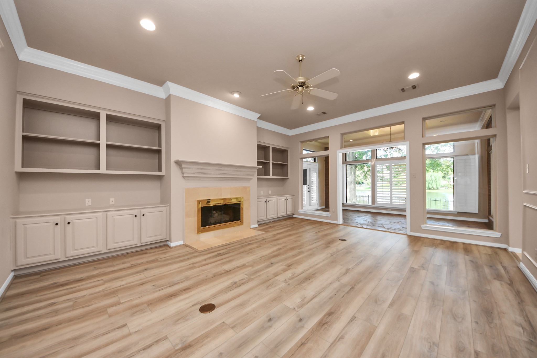 39 Wild Meadow Court The Woodlands, TX 77380 - Photo 11 of 41 a view of an empty room with a fireplace and a window