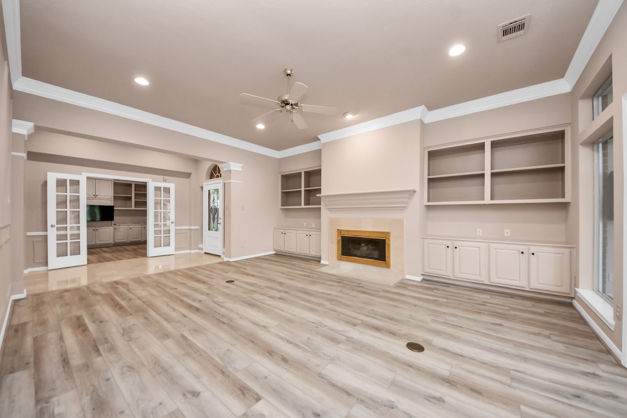 39 Wild Meadow Court The Woodlands, TX 77380 - Photo 12 of 41 a view of an empty room with a fireplace and a window