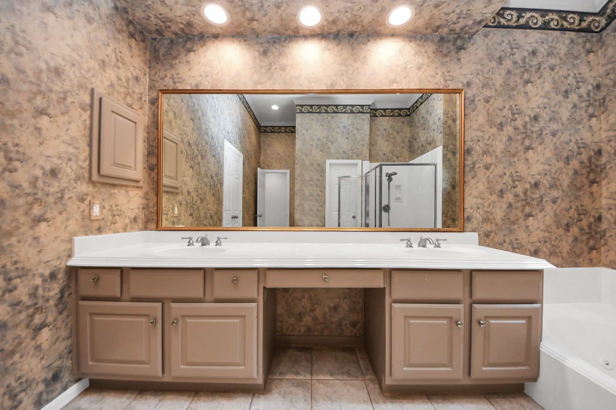 39 Wild Meadow Court The Woodlands, TX 77380 - Photo 20 of 41 a view of a bathroom with a sink and a mirror