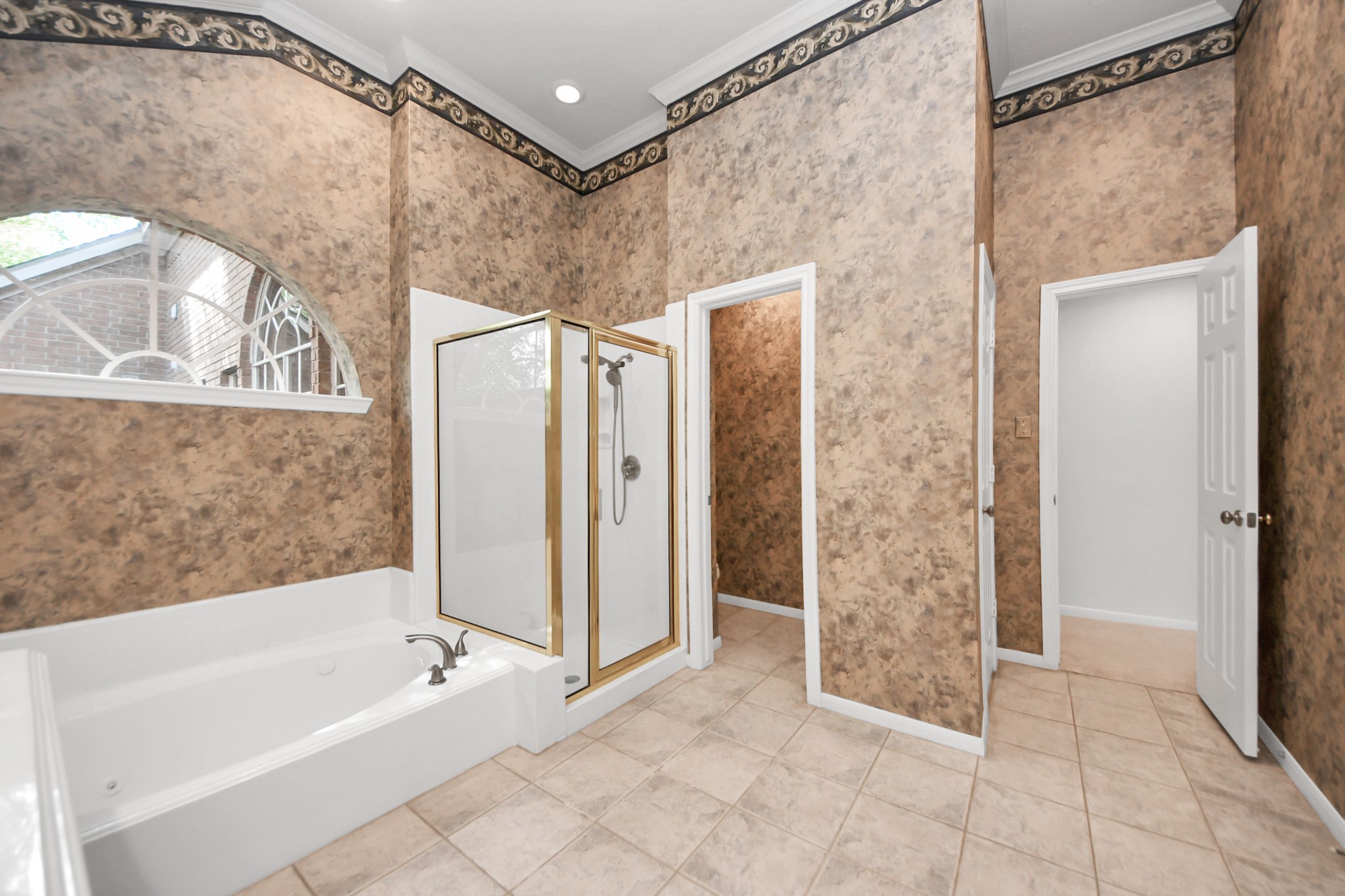 39 Wild Meadow Court The Woodlands, TX 77380 - Photo 21 of 41 a bathroom with a bathtub and a shower