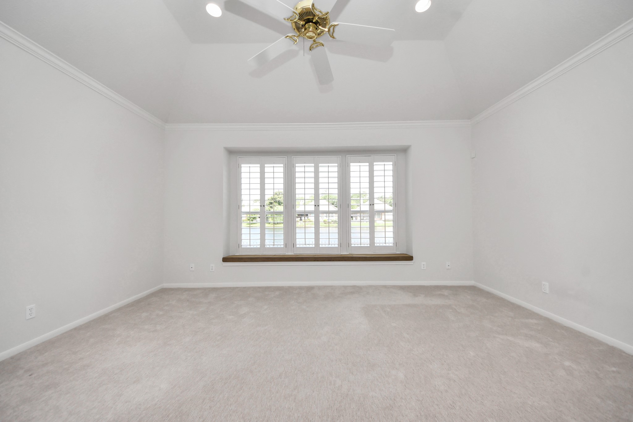 39 Wild Meadow Court The Woodlands, TX 77380 - Photo 26 of 41 an empty room with a chandelier fan and windows