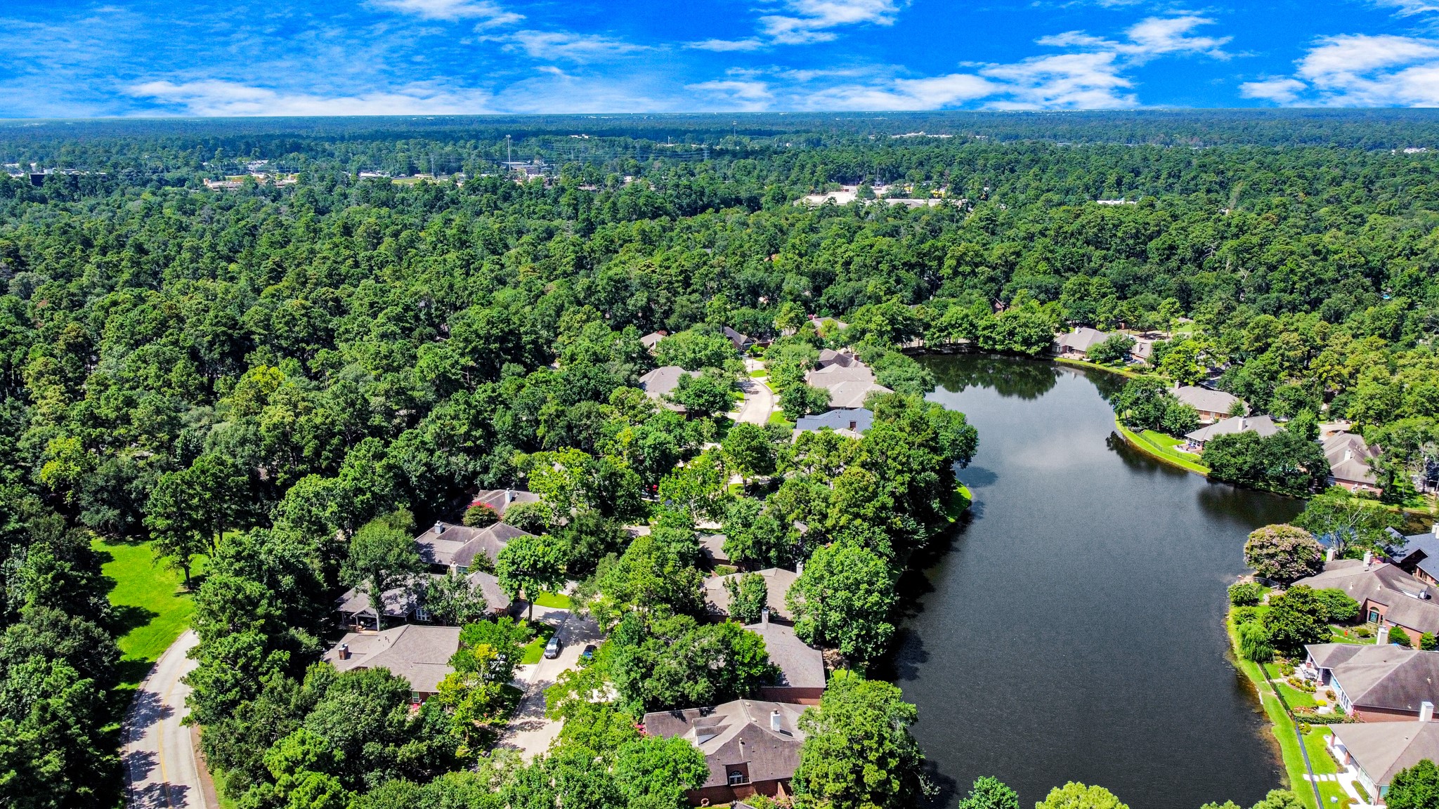39 Wild Meadow Court The Woodlands, TX 77380 - Photo 39 of 41 a view of a lake with a yard