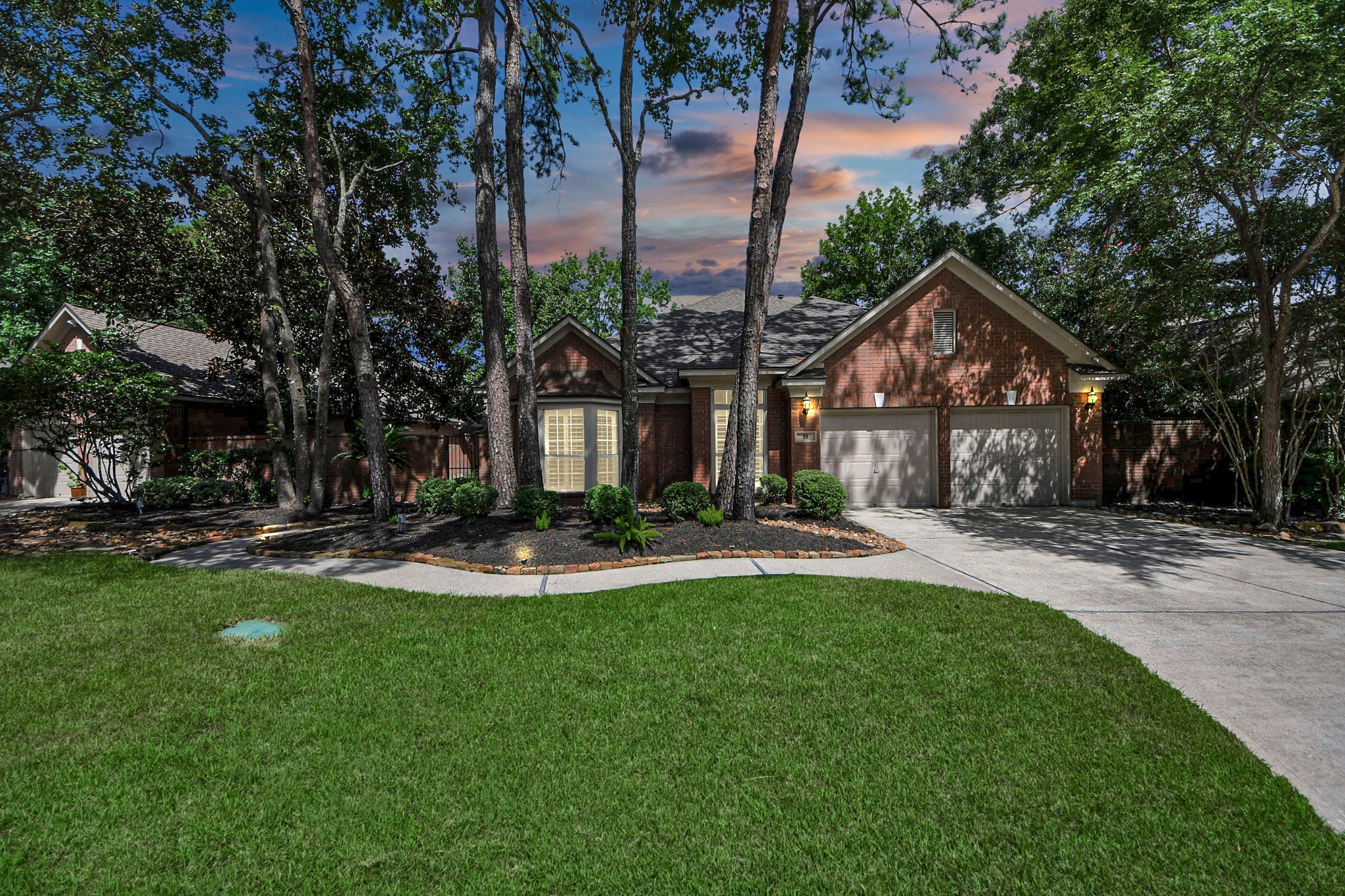 39 Wild Meadow Court The Woodlands, TX 77380 - Photo 4 of 41 a front view of a house with swimming pool and garden