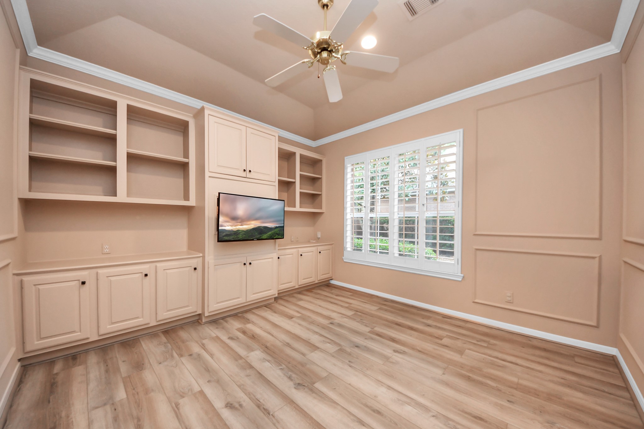 39 Wild Meadow Court The Woodlands, TX 77380 - Photo 10 of 41 a view of an empty room with a window and a kitchen