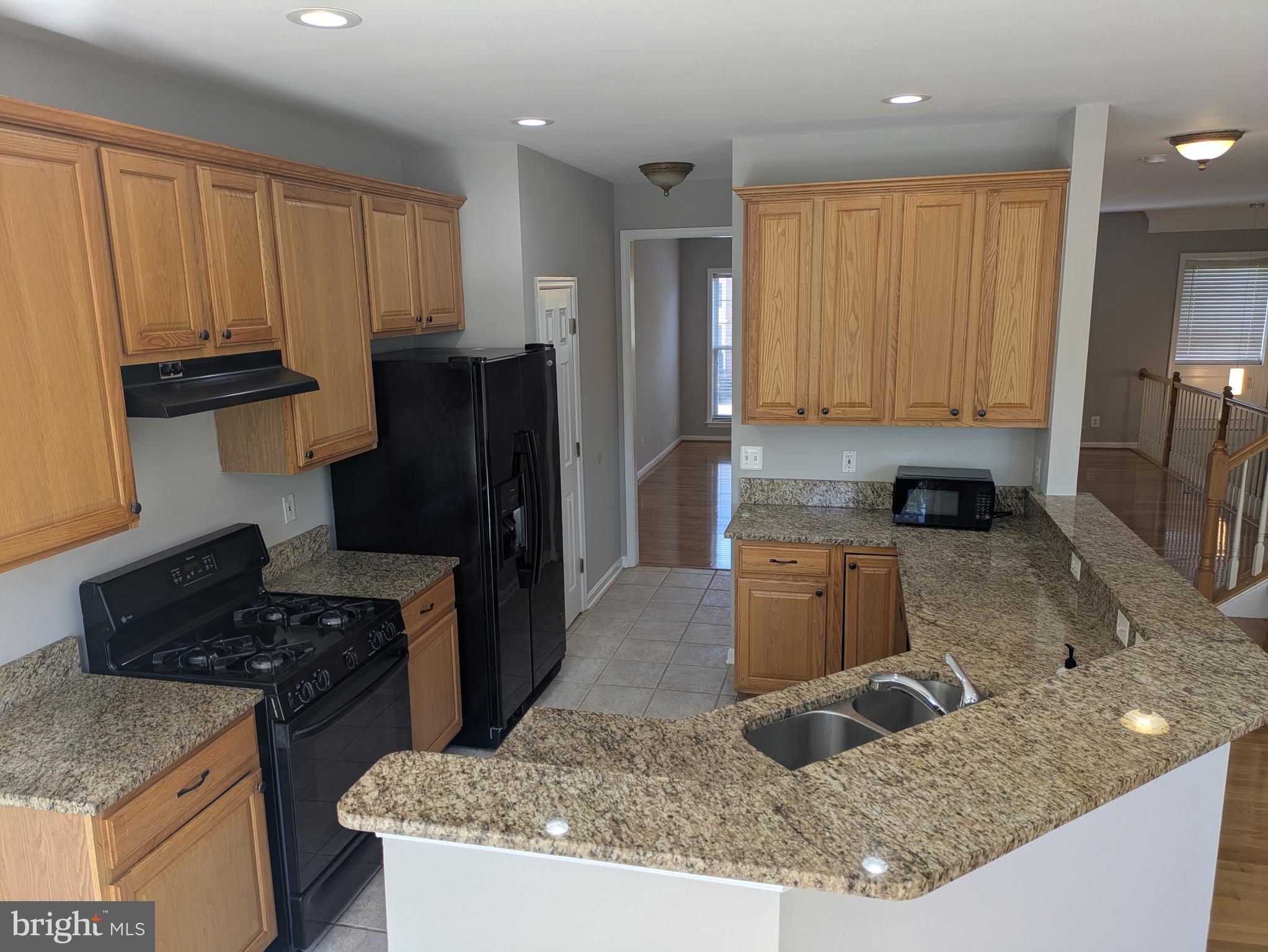 4016 Timber Oak Trail Fairfax, VA 22033 - Photo 17 of 67 a kitchen with granite countertop a sink a stove and refrigerator