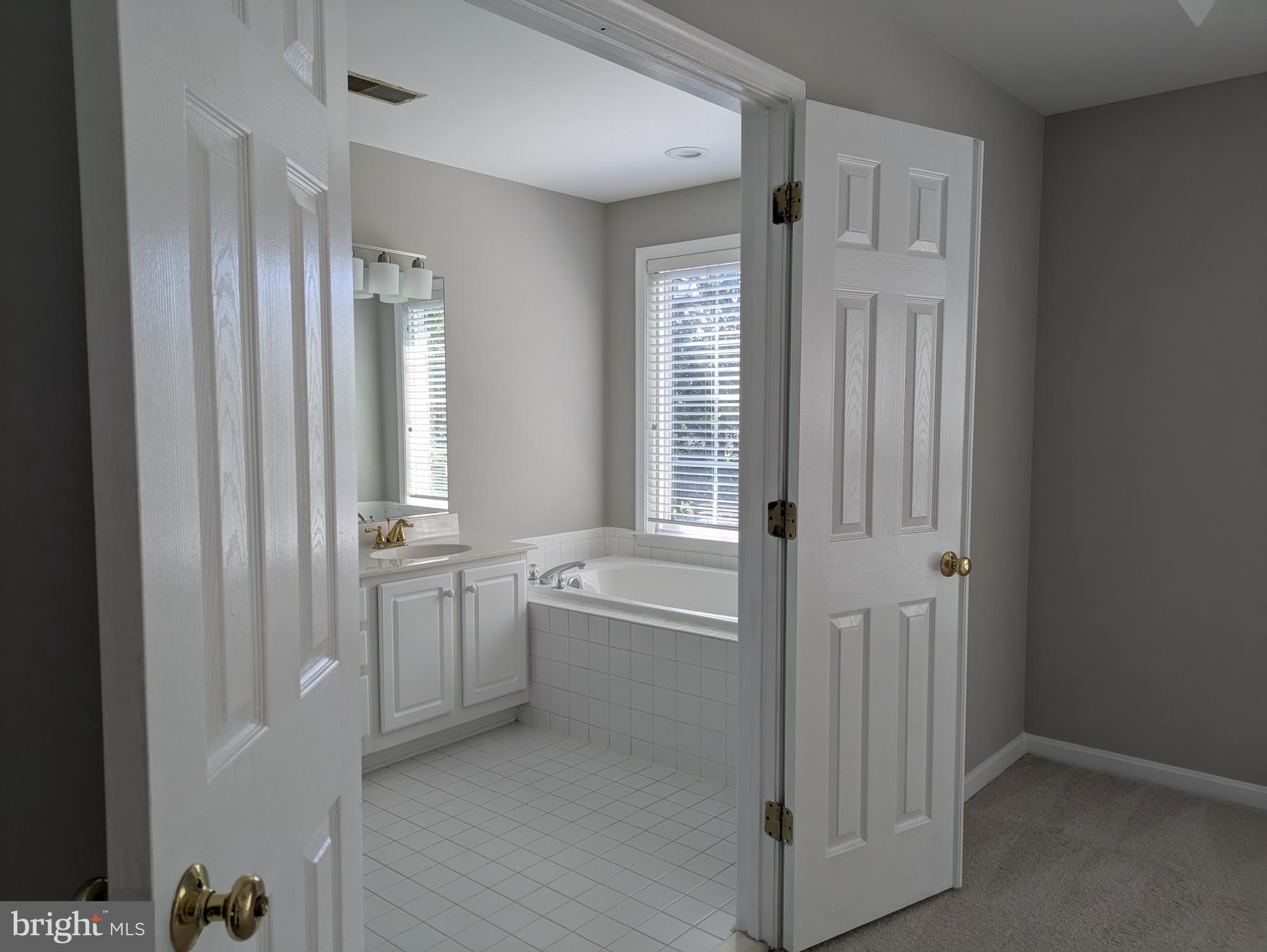 4016 Timber Oak Trail Fairfax, VA 22033 - Photo 42 of 67 a bathroom with bathtub a shower and a sink