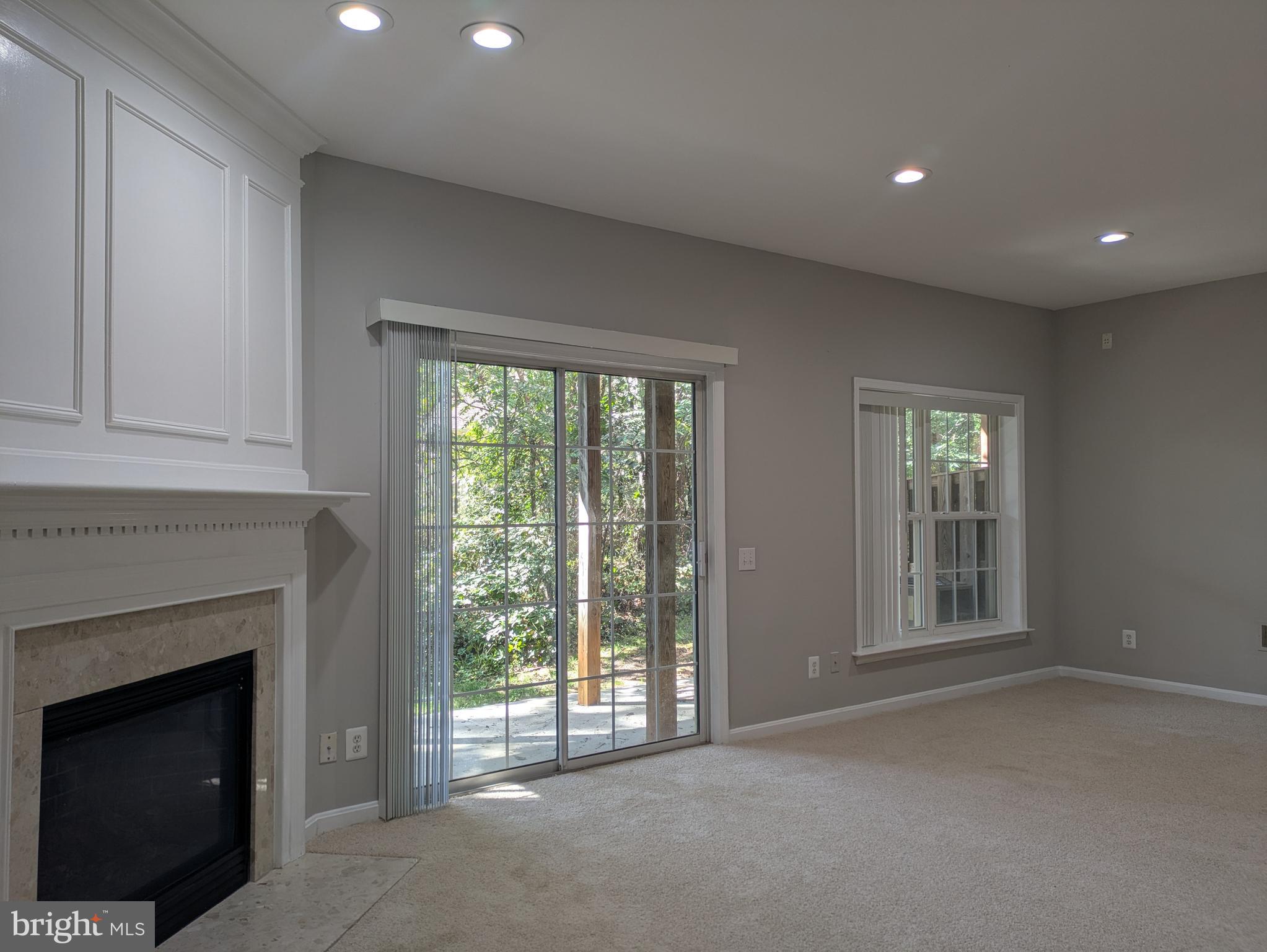 4016 Timber Oak Trail Fairfax, VA 22033 - Photo 57 of 67 a view of an empty room with a fireplace and a window