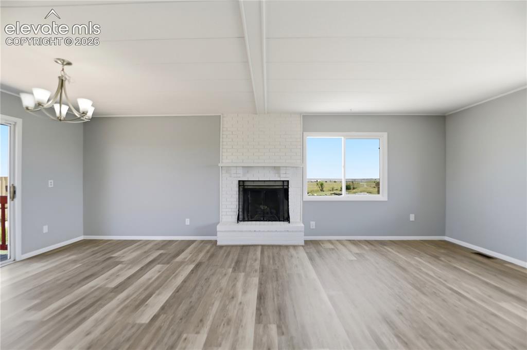 19027 Murphy Road Peyton, CO 80831 - Photo 4 of 48 Vinyl Plank, Fireplace, Sliding Door To Deck