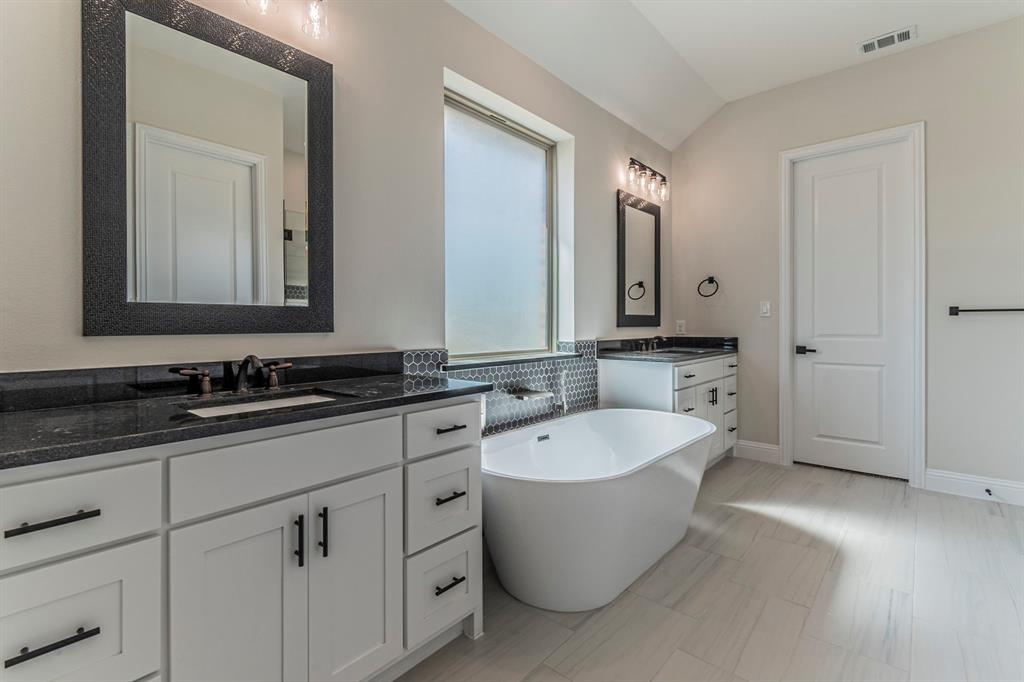 26 Kentucky Court Van Alstyne, TX 75495 - Photo 18 of 40 a bathroom with a bathtub a double vanity sink and mirror