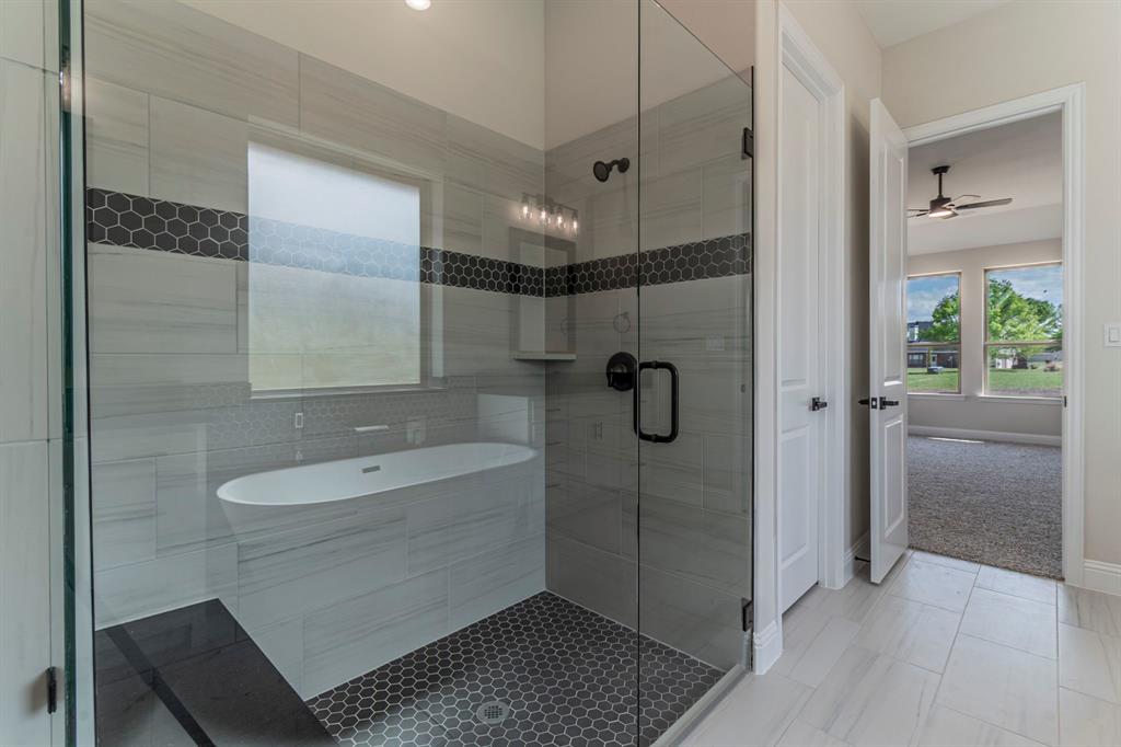 26 Kentucky Court Van Alstyne, TX 75495 - Photo 19 of 40 a bathroom with a shower a sink and a mirror