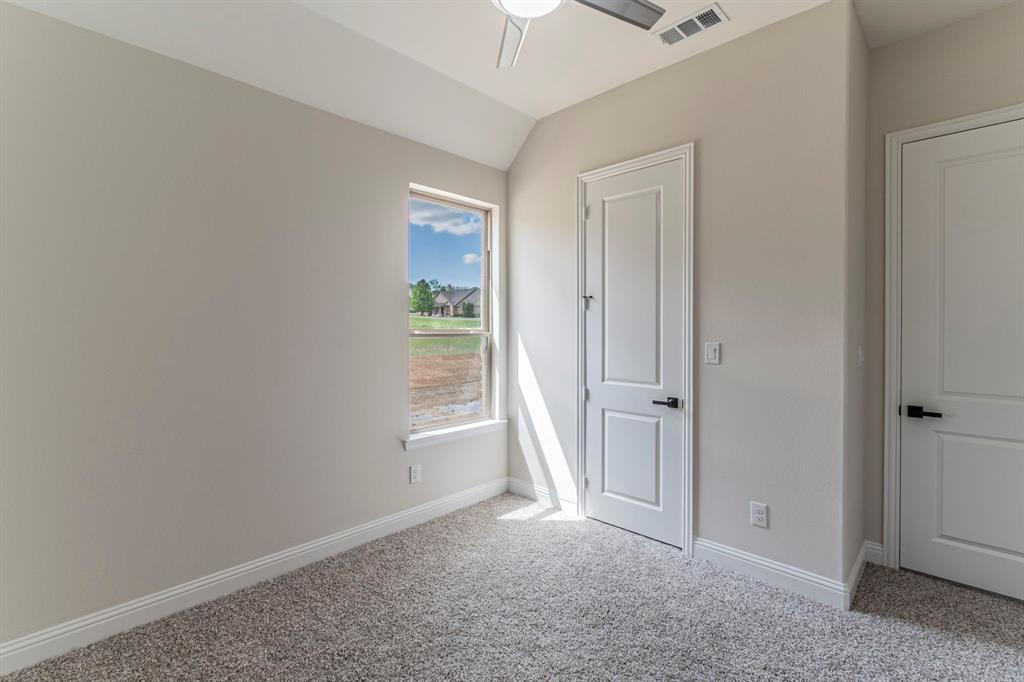 26 Kentucky Court Van Alstyne, TX 75495 - Photo 24 of 40 an empty room with windows and closet