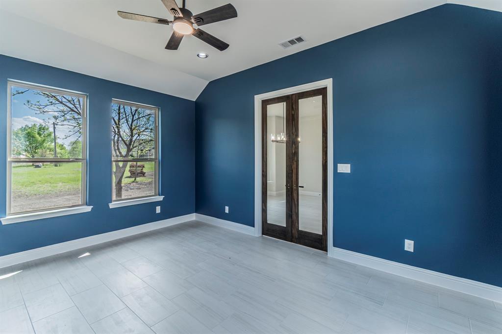 26 Kentucky Court Van Alstyne, TX 75495 - Photo 27 of 40 a view of an empty room with a window and a ceiling fan