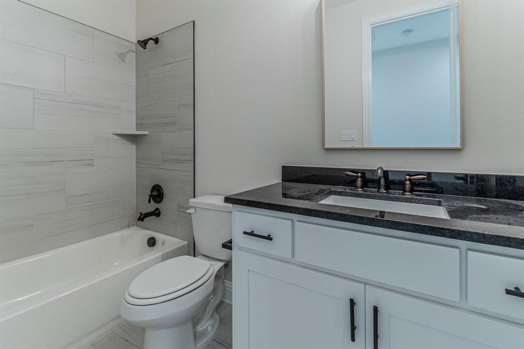 26 Kentucky Court Van Alstyne, TX 75495 - Photo 31 of 40 a bathroom with a sink a toilet and a bathtub