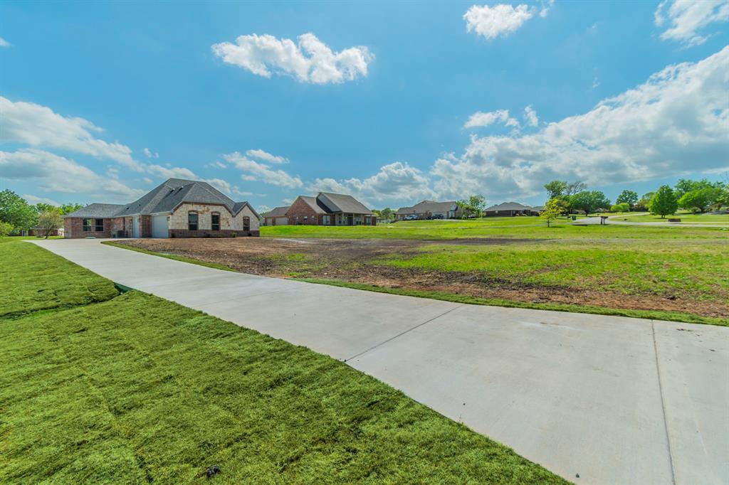 26 Kentucky Court Van Alstyne, TX 75495 - Photo 32 of 40 a view of a house with a big yard