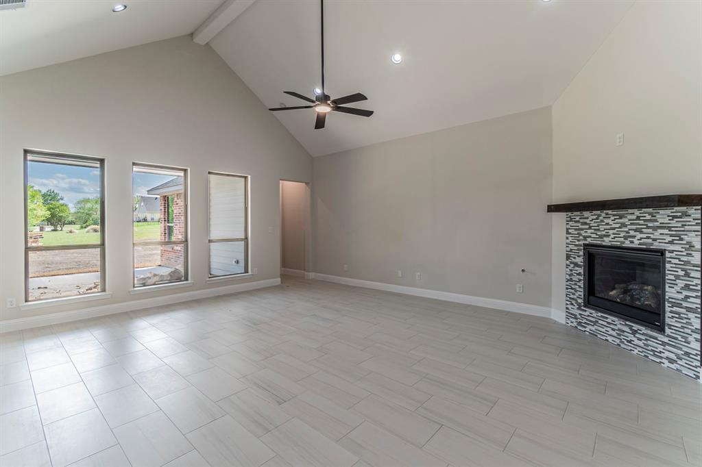 26 Kentucky Court Van Alstyne, TX 75495 - Photo 5 of 40 an empty room with windows and fireplace