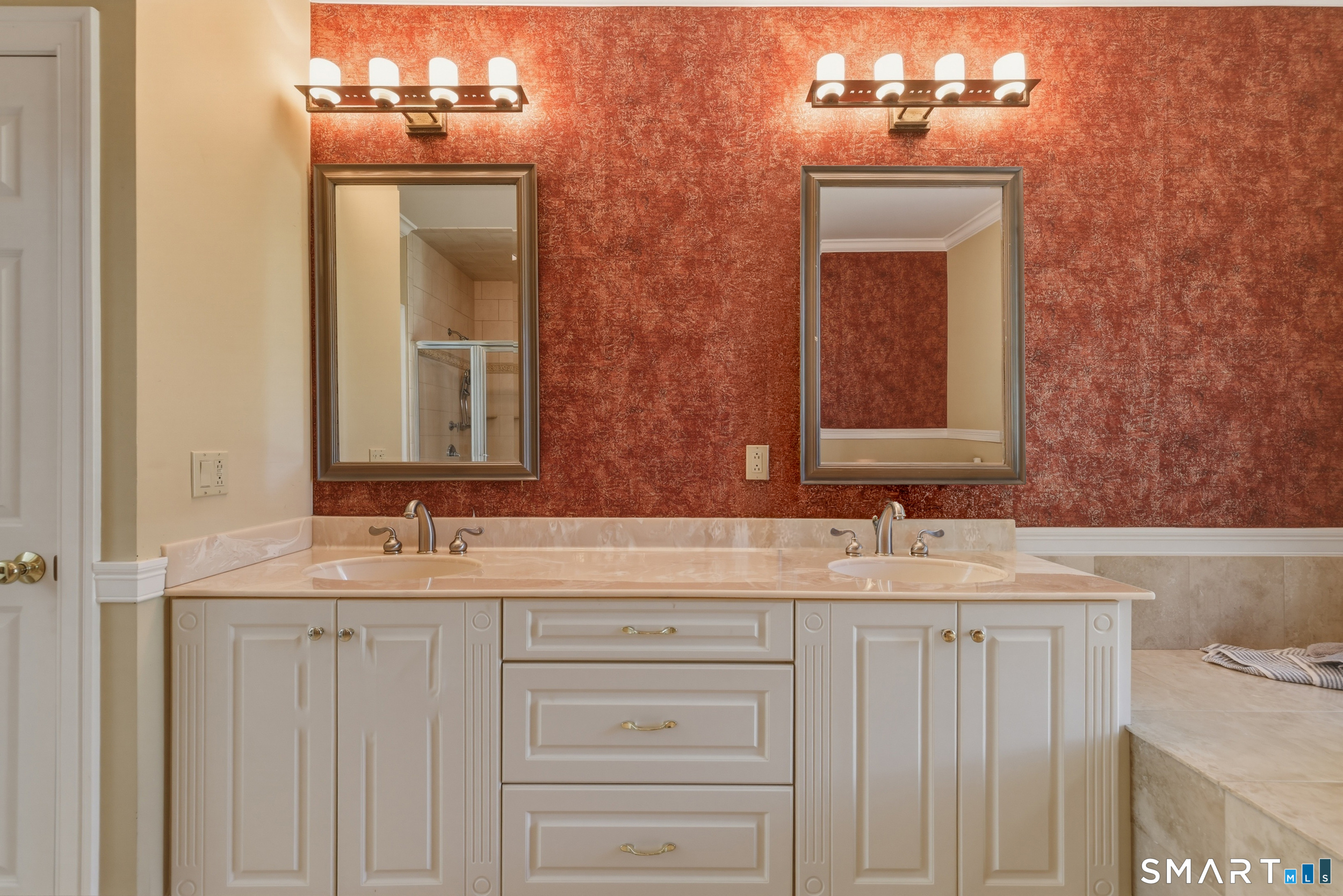 122 Lower Road Guilford, CT 06437 - Photo 16 of 40 The master bath offers a generous layout with tile flooring, crown molding, a dual-sink vanity, walk-in shower, and separate soaking tub. A linen closet provides additional convenient storage.