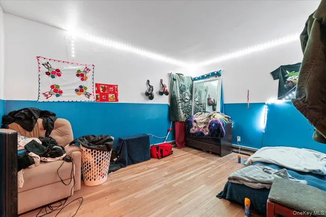 a bedroom with furniture and a wooden floor