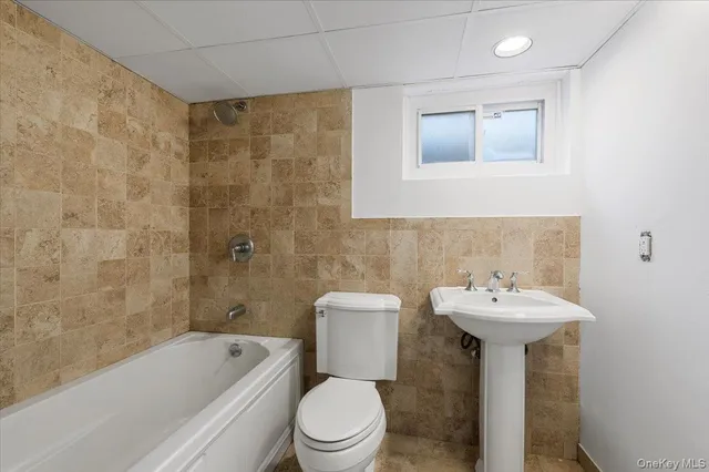 a bathroom with a sink a toilet and bathtub