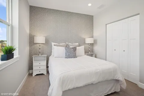 a bedroom with a bed and a potted plant