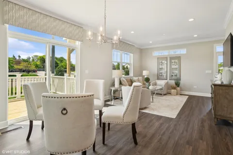 a living room with furniture dining table and a large window