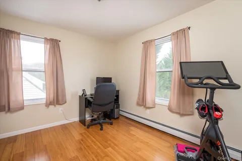 a view of a workspace with furniture and a window