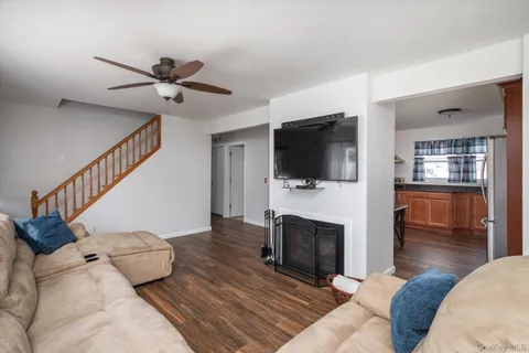 a living room with fireplace furniture and a flat screen tv