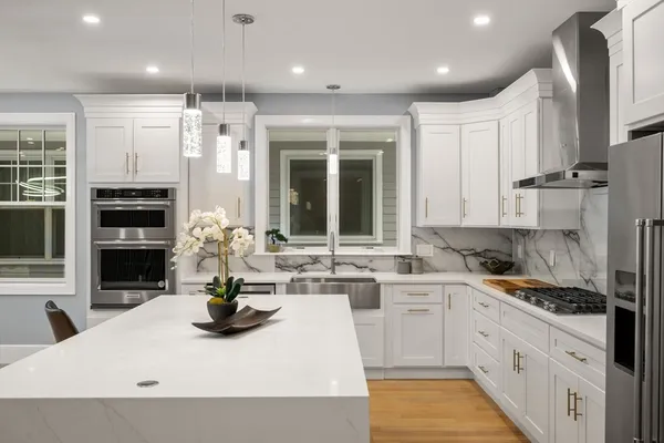 a kitchen with stainless steel appliances kitchen island granite countertop a sink and cabinets