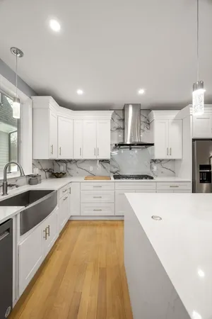 a large kitchen with stainless steel appliances kitchen island granite countertop a sink and cabinets