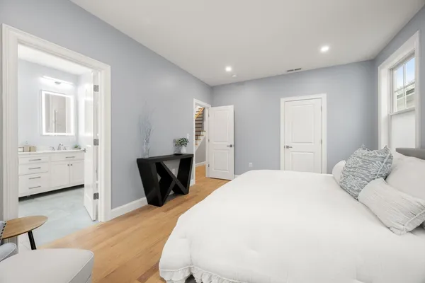 a bedroom with a bed and wooden floor