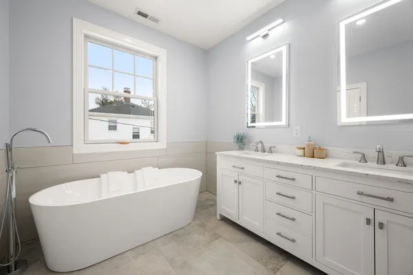 a bath room with a sink and a mirror