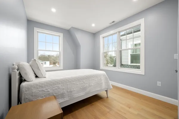 a bedroom with a bed and window