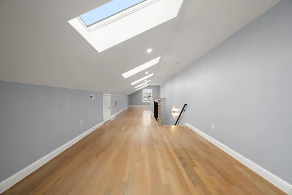 a view of empty room with wooden floor