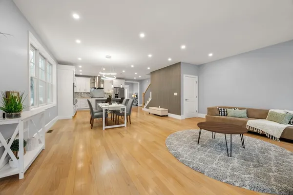 a living room with furniture and wooden floor