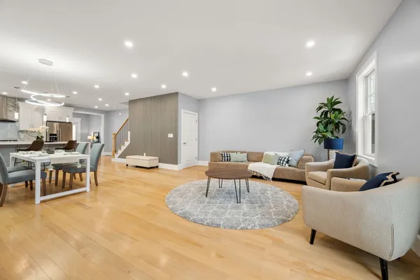 a living room with furniture and kitchen view