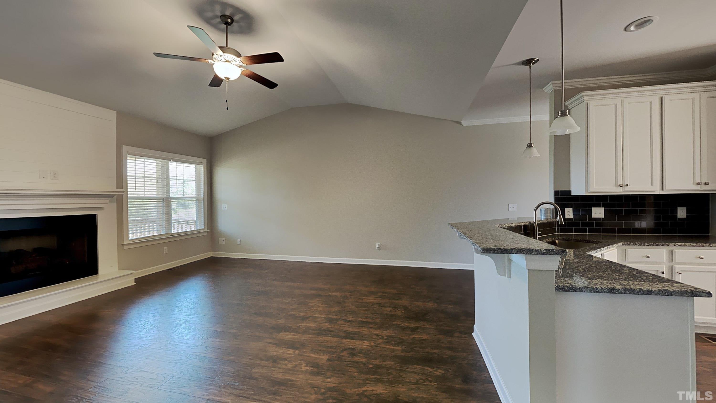 1265 Bill Avery Road Coats, NC 27521 - Photo 5 of 19 a view of a kitchen with a stove wooden floor and a window