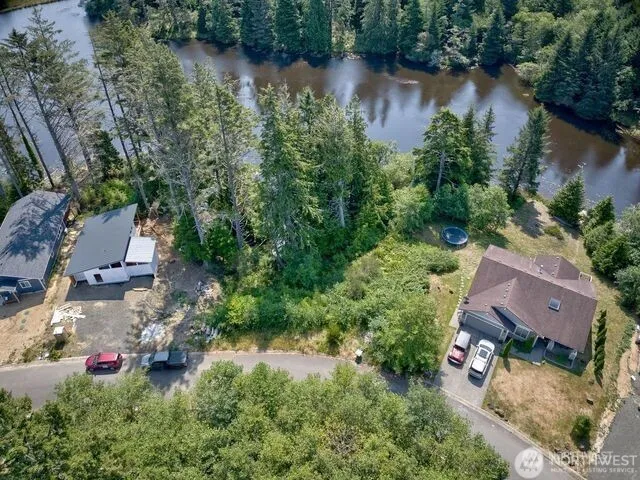 an aerial view of house with yard and lake view