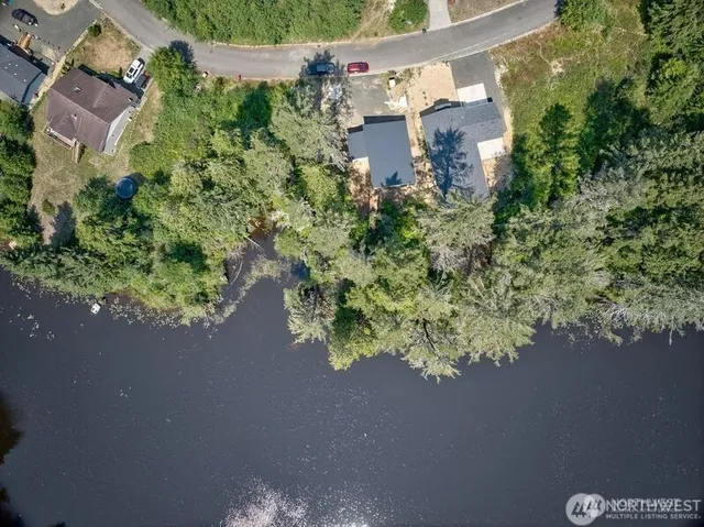 an aerial view of a house with a yard and garden in the back