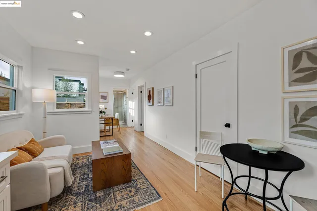 a dining room with furniture and wooden floor
