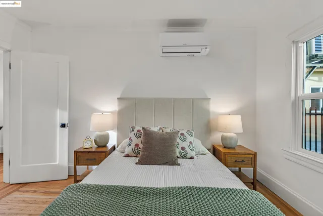 a bedroom with a bed and a large window