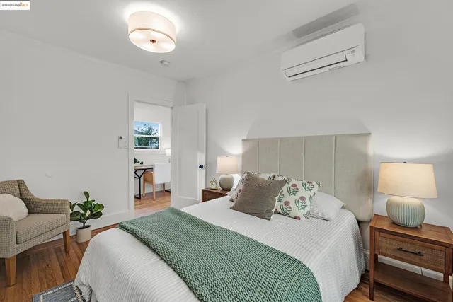 a bedroom with a bed and a painting on the wall