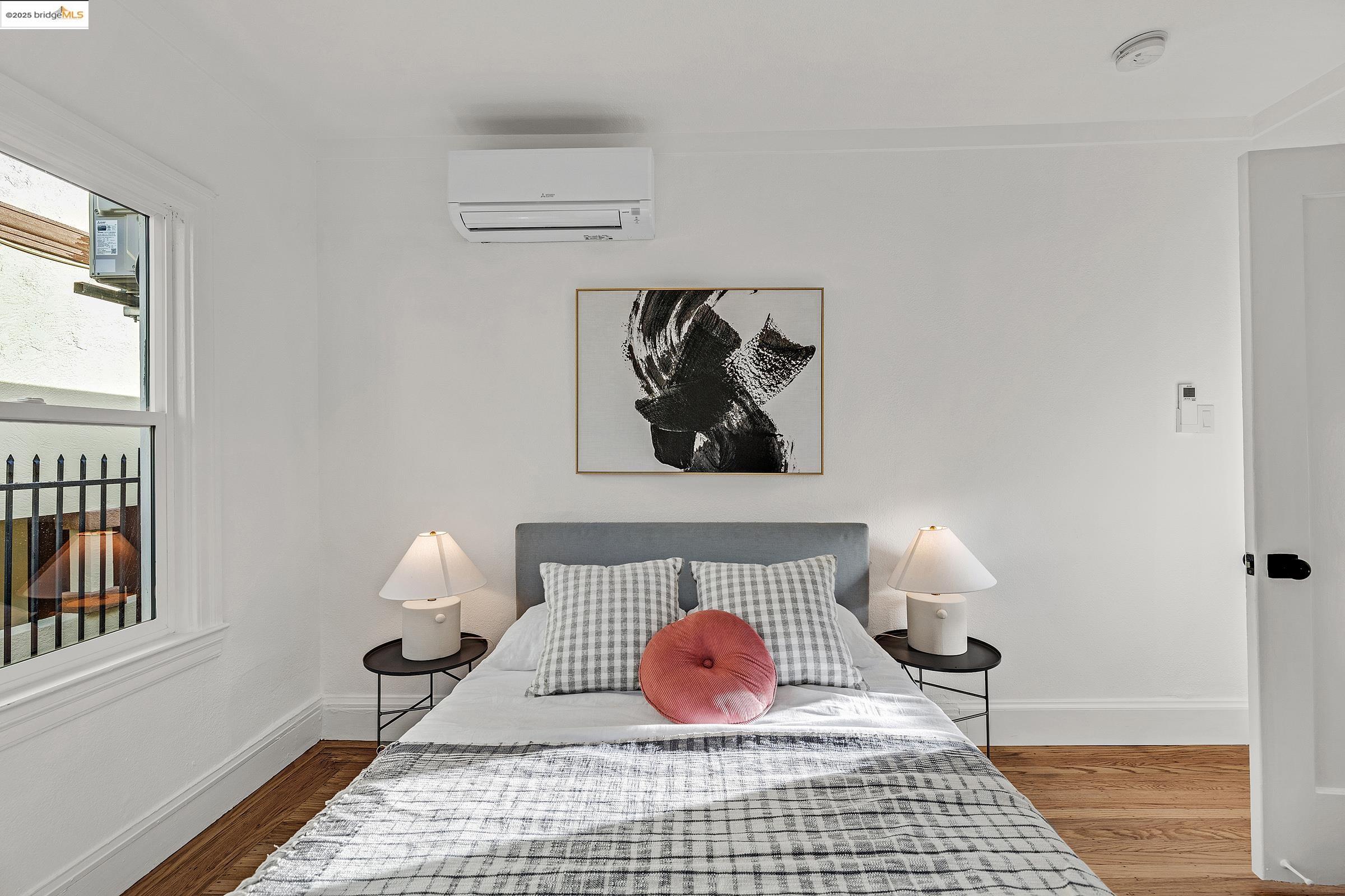 1515 B Derby Street Berkeley, CA 94703 - Photo 27 of 29 a bedroom with a bed and wooden floor