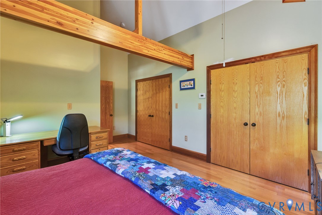 176 Baypointe Court Reedville, VA 22539 - Photo 45 of 60 a bedroom with a bed and a chair