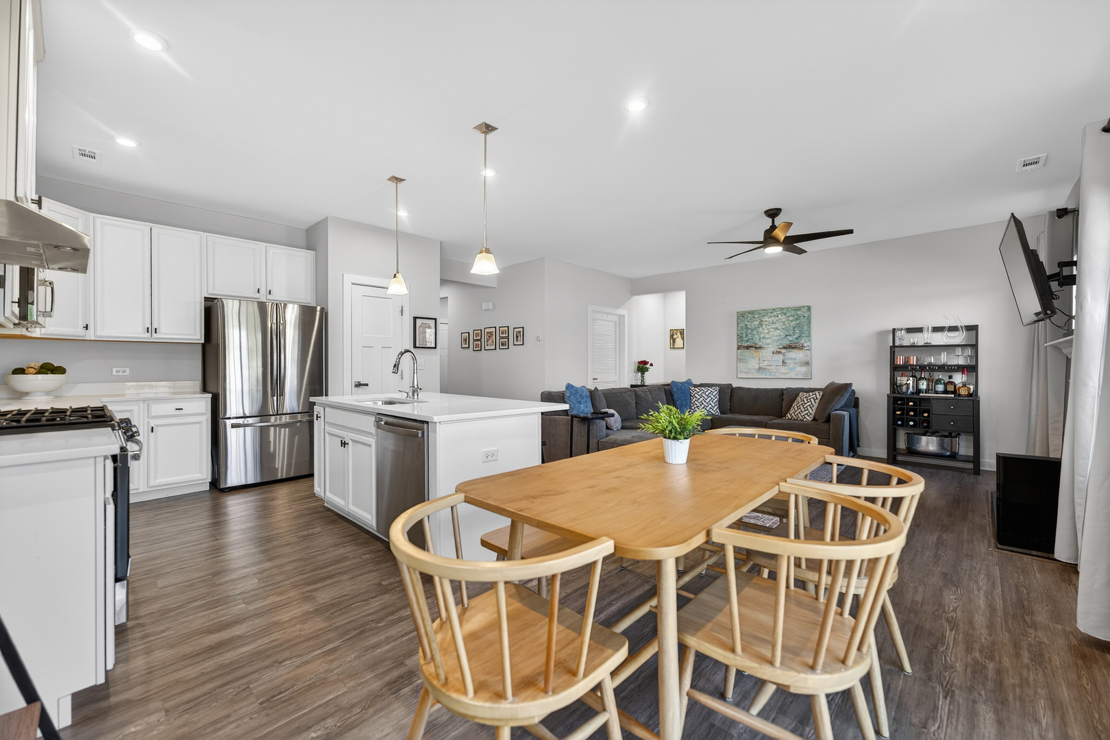 3656 Reddington Circle Elgin, IL 60124 - Photo 16 of 35 a kitchen with stainless steel appliances kitchen island granite countertop a dining table chairs and granite counter tops