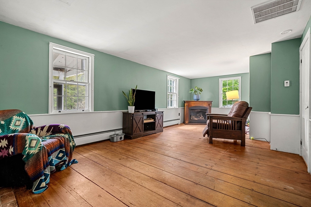 600 Main Street Ashby, MA 01431 - Photo 13 of 40 a living room with furniture and a flat screen tv